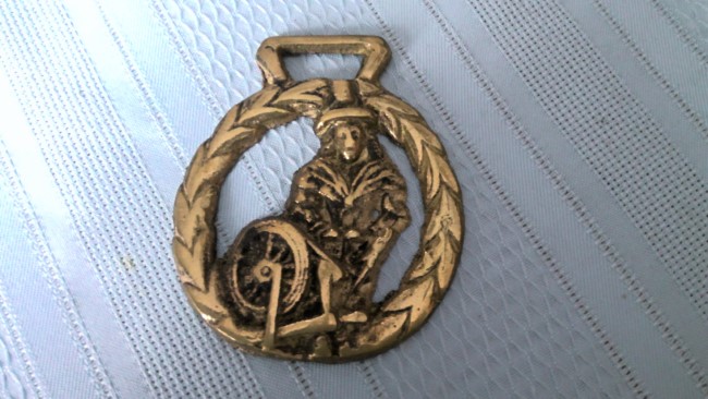 Puritan at Spinning Wheel Brass Medallion for sale on heinventures.ca